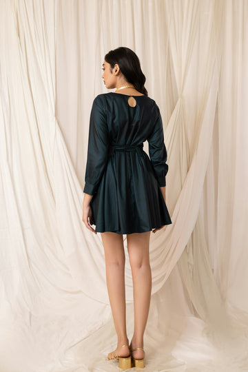 Woman in dark green dress with belt and keyhole back