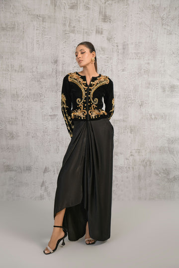 A woman wearing a black and gold dress