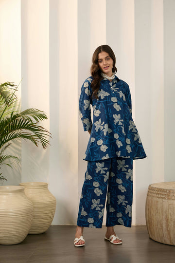 Woman in blue floral print tunic and wide-leg pants