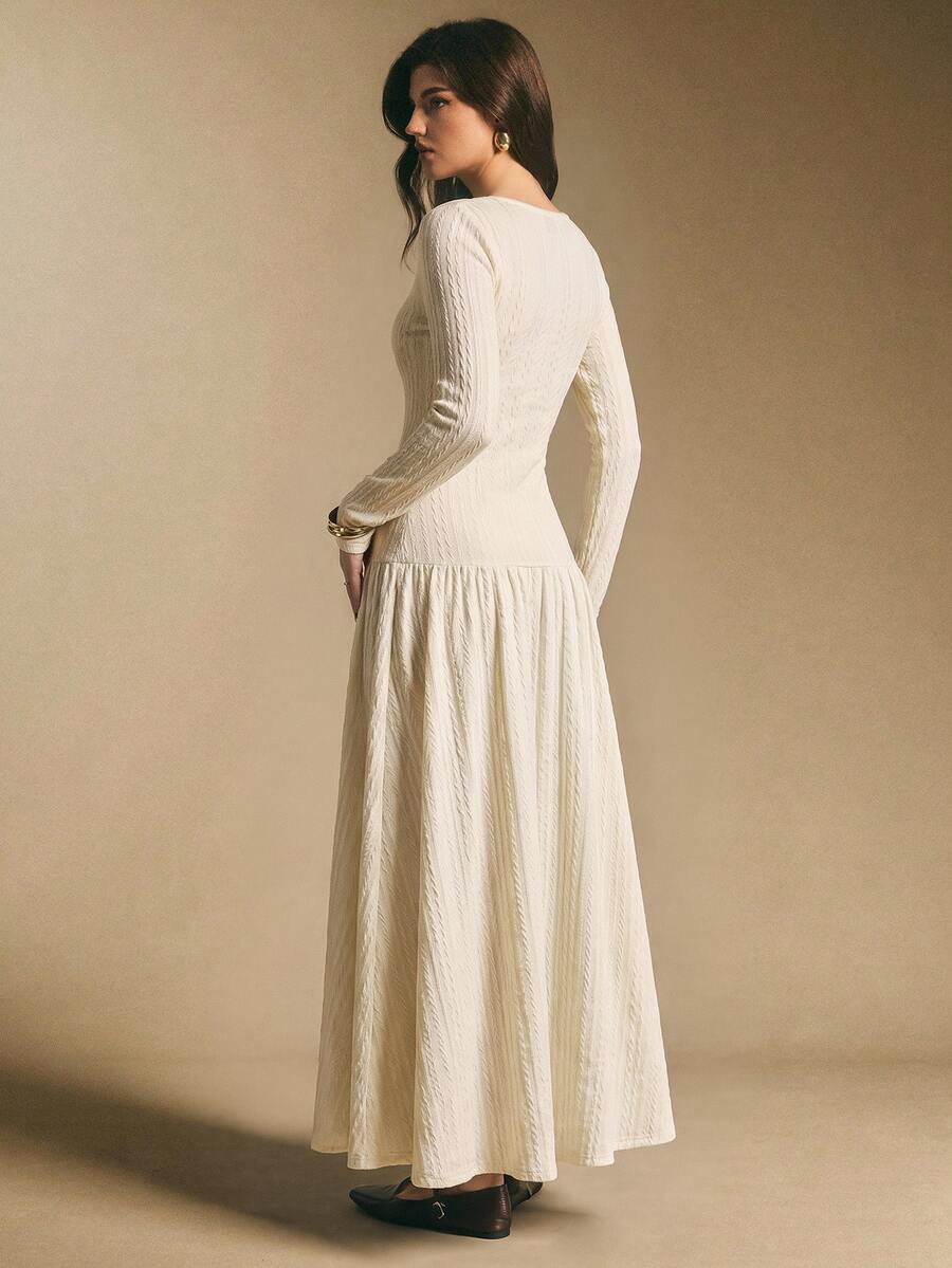 Back view of the ivory white textured maxi dress showing fitted waist and full flowing skirt