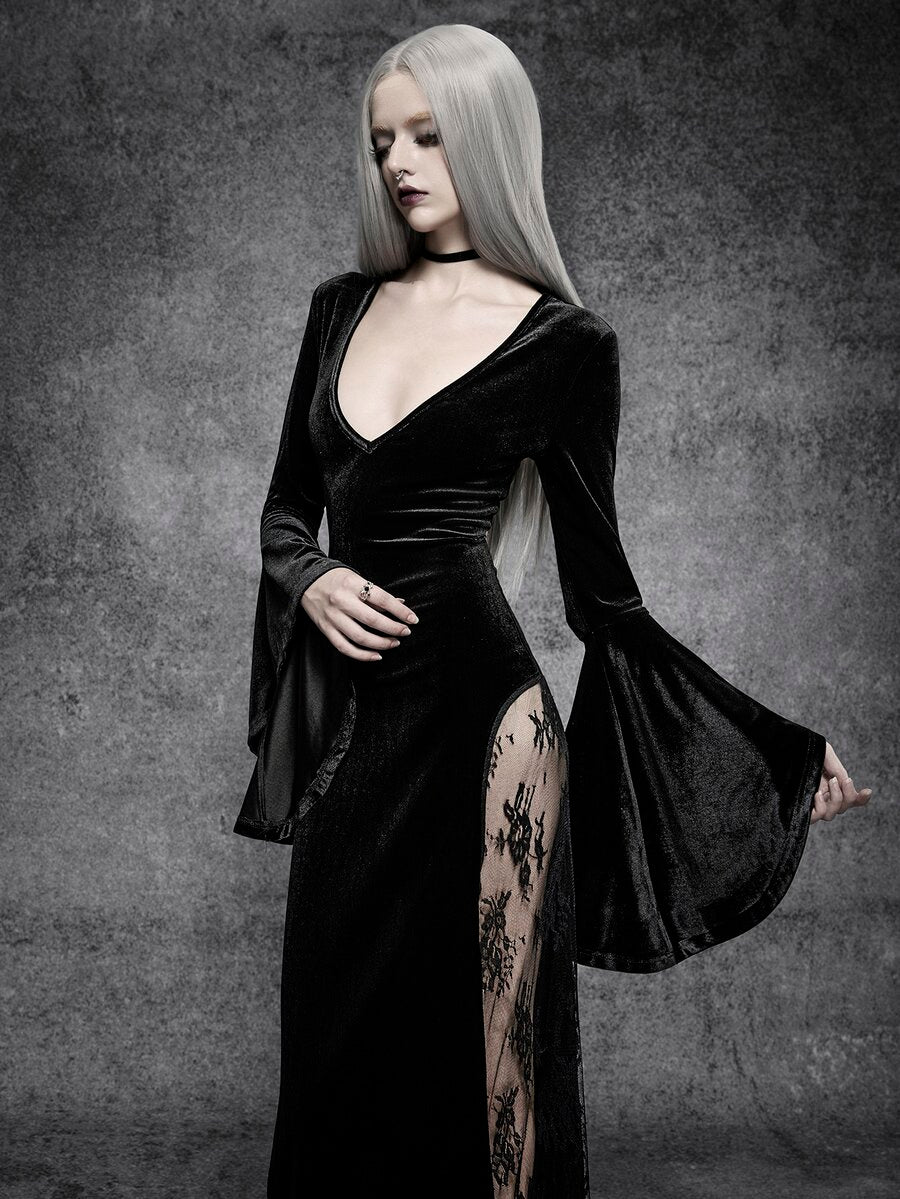 Close-up of black velvet deep V bodice, fitted waist, and dramatic cloak sleeve on gothic maxi dress