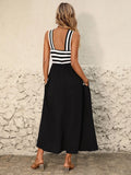 Back view of black halter midi dress with striped open back and tie-back detail