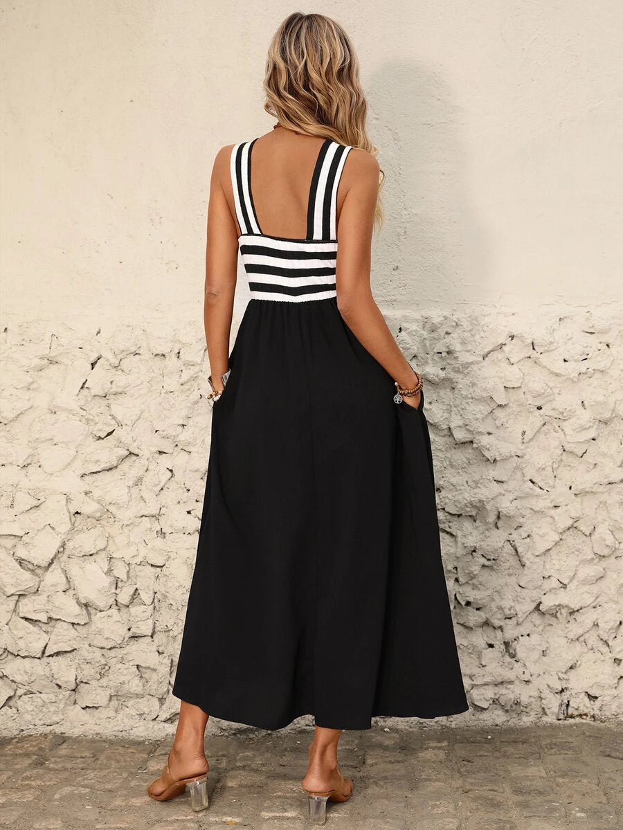 Back view of black halter midi dress with striped open back and tie-back detail
