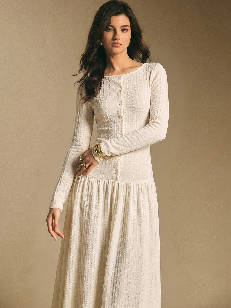 Close front view of the ivory white textured maxi dress showing round neckline, front buttons, and long sleeves