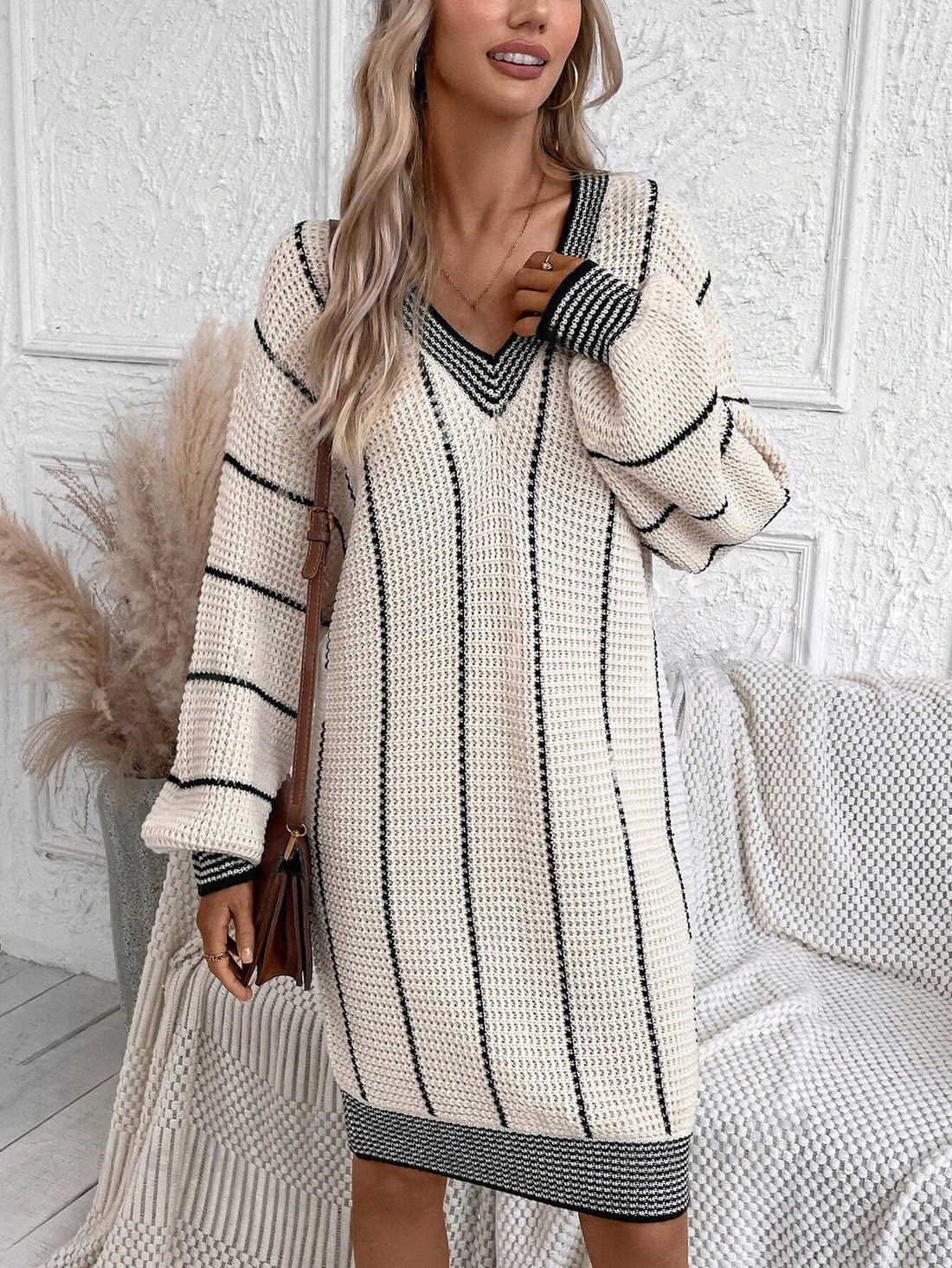 Discover the ultimate comfort and style with our Cozy Chic: Striped Pattern Drop Shoulder Sweater Dress. Featuring a chic striped pattern, drop shoulder design, and crafted from cozy fabric, this dress will keep you warm, stylish, and effortlessly on-trend. Perfect for any occasion, stay cozy and chic with our sweater dress.