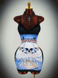 Angled view of black skull graphic cami bodycon mini dress