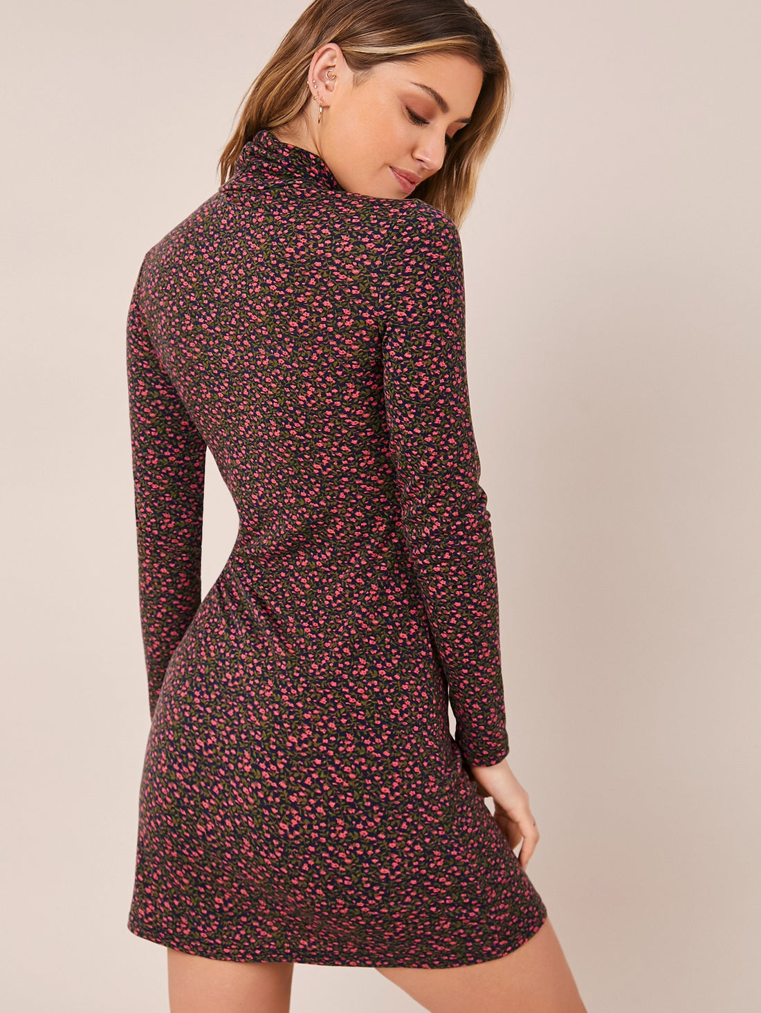 This chic mock neck dress is perfect for any occasion. The ditsy floral pattern adds a touch of style, while the mock neck provides a sophisticated look. A versatile option, this dress is perfect for both casual and formal events. Make a statement with this fashionable dress.