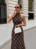 Cropped front view showing the brown plaid halter neckline, fitted bodice and diagonal cream check pattern.