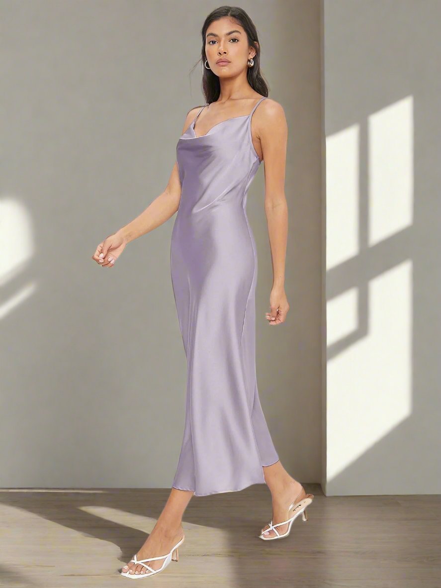 Upgrade your work attire with our Cowl Neck Solid Slip Dress. The elegant cowl neck design and solid color will elevate your professional look. You'll love the comfort and versatility of this slip dress. Perfect for the office and beyond.