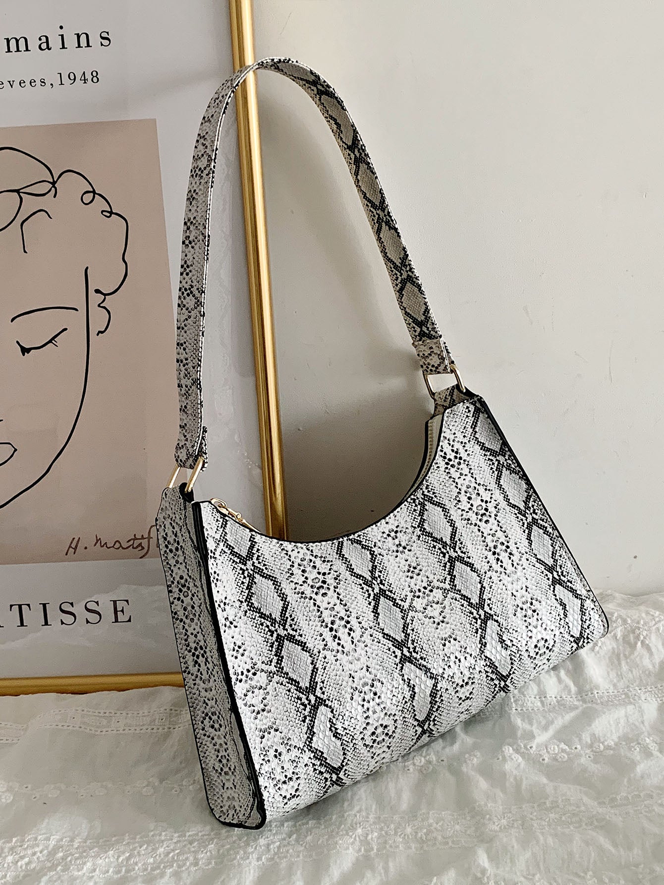 Introducing the Chic Snakeskin Print <a href="https://canaryhouze.com/collections/canvas-tote-bags?sort_by=created-descending" target="_blank" rel="noopener">Bag</a>, the perfect statement piece for any fashionista. This bag features a luxurious snakeskin print that adds a touch of elegance to any outfit. Made with high-quality materials, it is both stylish and durable. Elevate your wardrobe with this must-have accessory.