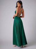 Back view of dark green gown with crisscross straps and flowing skirt