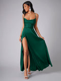 Deep green satin slit dress shown in a front pose