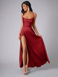 Burgundy slit gown shown in a flowing pose from the front