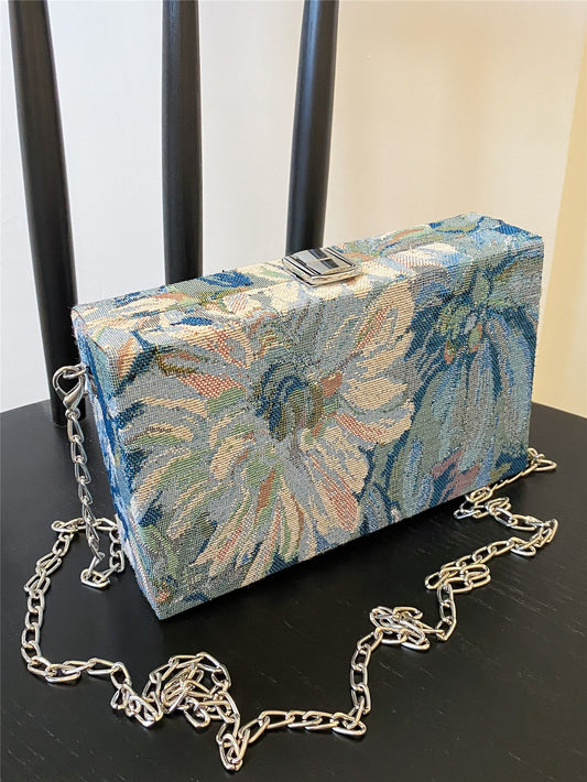 This elegant mini chain box bag features a beautiful floral pattern, making it the perfect accessory for any outfit. Crafted with high-quality materials, it offers both style and functionality. Elevate your fashion game with this must-have accessory.