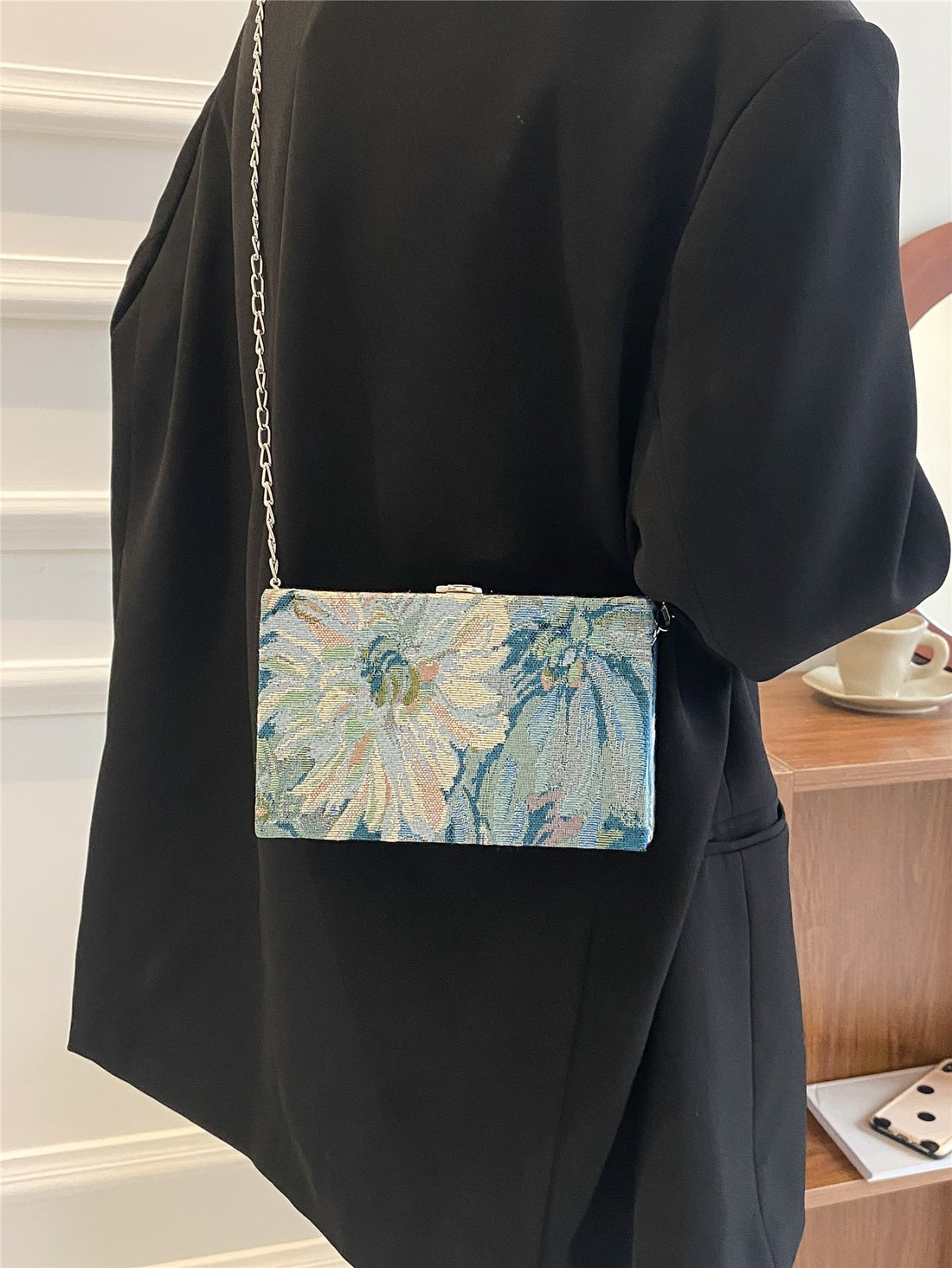 This elegant mini chain box bag features a beautiful floral pattern, making it the perfect accessory for any outfit. Crafted with high-quality materials, it offers both style and functionality. Elevate your fashion game with this must-have accessory.