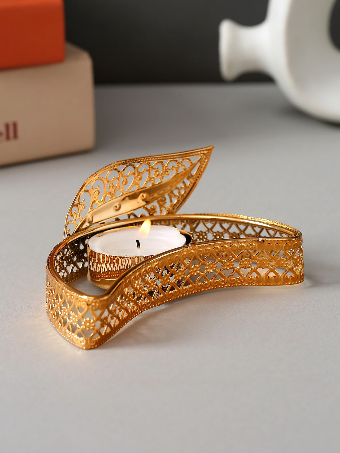 Add a touch of elegance to your space with the Leafy Glow Candle Holder. The leafy design allows the candle's glow to shine through, creating a warm and inviting atmosphere. Crafted with style and functionality in mind, this candle holder is the perfect addition to any room.