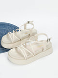 Cream flatform slingback sandals side view showing neutral straps and platform height
