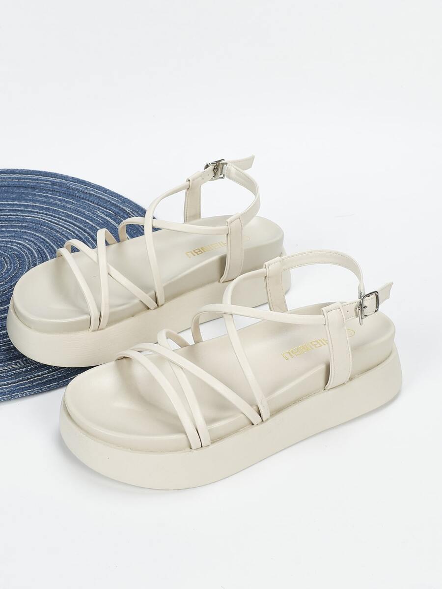 Cream flatform slingback sandals side view showing neutral straps and platform height