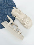 Black dressy flatform sandals close view with wide toe band braided strap and buckle
