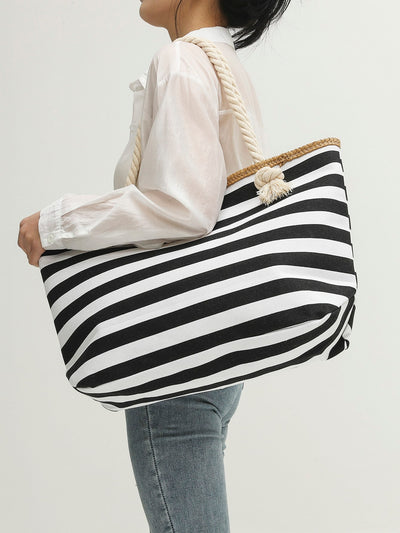 This Striped Shoulder Tote Bag is a versatile and stylish carryall that is perfect for both school and travel. With its chic striped design and shoulder straps, this bag is both functional and fashionable. The spacious interior allows for easy organization of all your essentials, while the durable material ensures long-lasting use.
