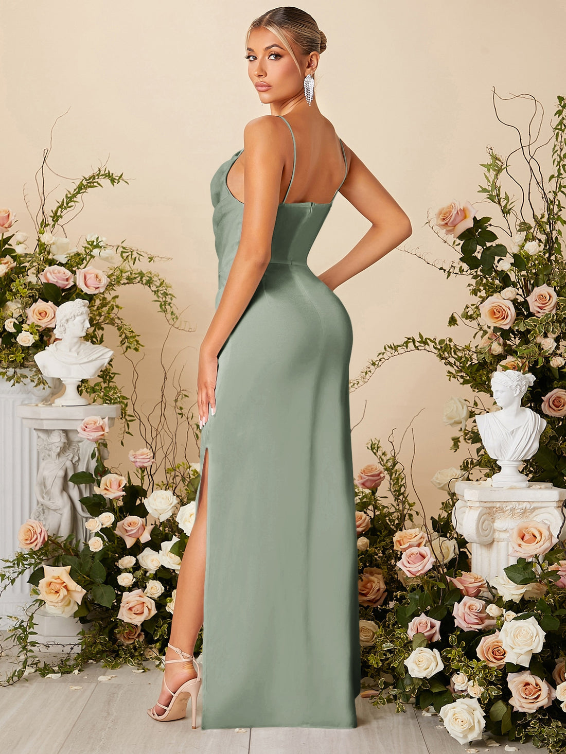 This chic satin bridesmaid dress features a pleated front and thigh slit, adding a touch of elegance to any wedding party. Look effortlessly stylish and stand out in this unique dress. (Bonus: No need to worry about tripping over your dress on the dance floor!)