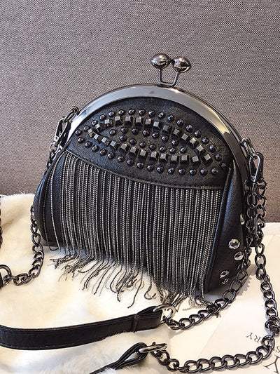 Elevate your personal style with our Punk Gothic Kiss-Lock Clutch. Featuring a unique rock-style design with rivet tassel, this novelty bag is perfect for making a statement. Indulge in the edgy appeal while keeping your essentials safe with its kiss-lock closure. A must-have for any fashion-forward woman.