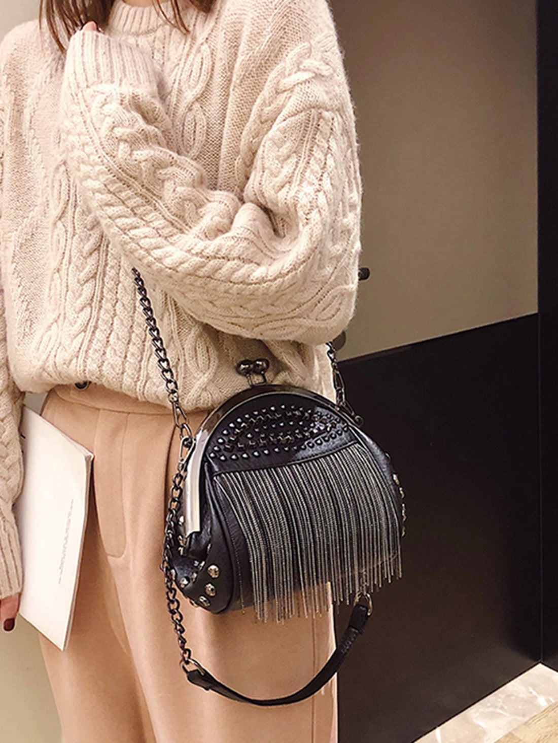 Elevate your personal style with our Punk Gothic Kiss-Lock Clutch. Featuring a unique rock-style design with rivet tassel, this novelty bag is perfect for making a statement. Indulge in the edgy appeal while keeping your essentials safe with its kiss-lock closure. A must-have for any fashion-forward woman.