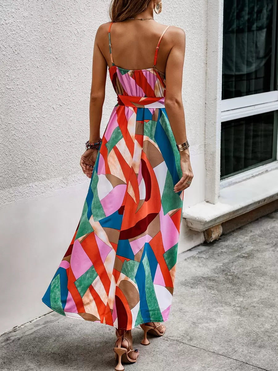 Rear view of multicolor spaghetti strap belted maxi dress with flowing skirt