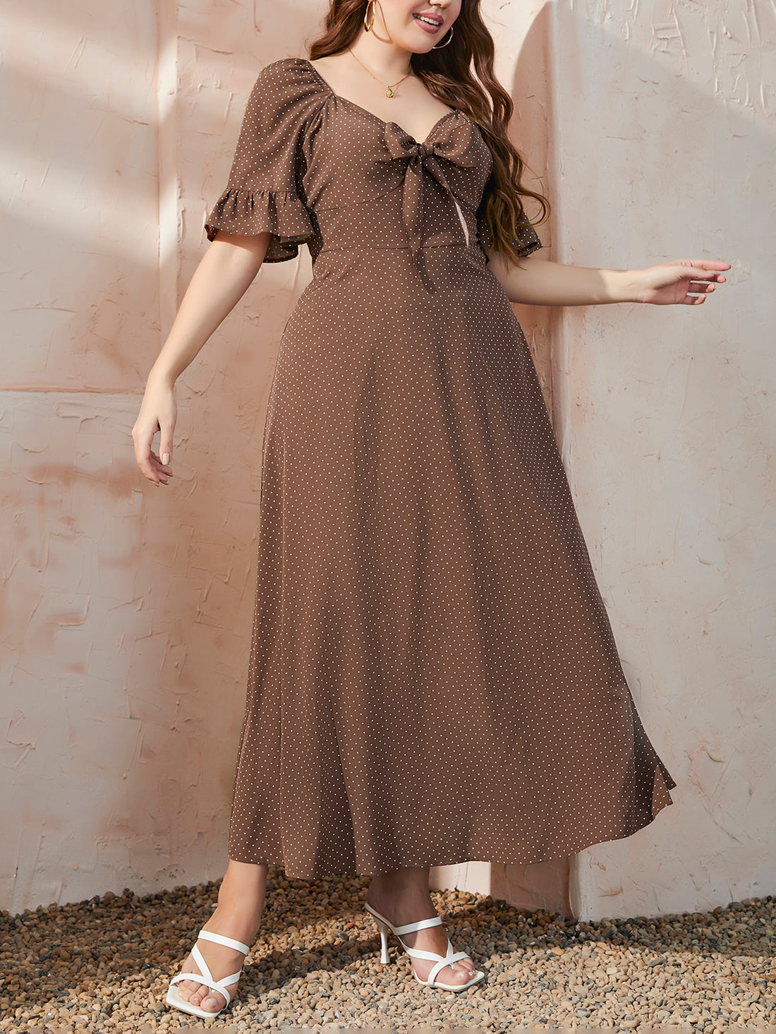 Embrace your curves in this playful polka dot A-line dress! The flounce sleeves add a flirty touch while the knot front detail creates a flattering silhouette. Perfect for summer brunches or evening strolls, this plus-size stunner lets you look fabulous without trying too hard. Just slip it on and you're ready to turn heads!