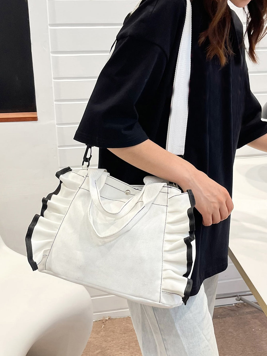 Expertly designed for every occasion, the Ruffled Elegance Shopper Bag adds a touch of sophistication to any outfit. With its unique ruffled design and spacious interior, this bag is the perfect accessory for any fashion-forward individual. Made with high-quality materials, it is durable and stylish, making it a must-have for any wardrobe.