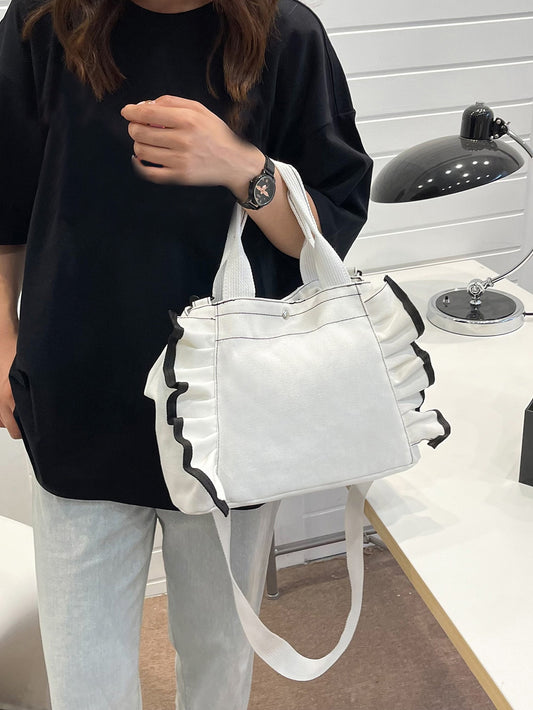 Expertly designed for every occasion, the Ruffled Elegance Shopper Bag adds a touch of sophistication to any outfit. With its unique ruffled design and spacious interior, this bag is the perfect accessory for any fashion-forward individual. Made with high-quality materials, it is durable and stylish, making it a must-have for any wardrobe.