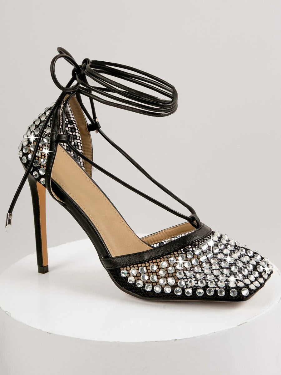 Elevate your wedding day look with these stunning Diamante Fish Net Lace-Up Heel Pumps! Featuring intricate fishnet detailing adorned with sparkling diamante accents, these pumps deliver glamour and sophistication. The lace-up design adds a touch of edgy elegance, while the sleek heel elongates your silhouette beautifully. Perfect for spring and summer celebrations, these show-stopping shoes transition seamlessly from ceremony to reception. Whether you're walking down the aisle or dancing the night away, th