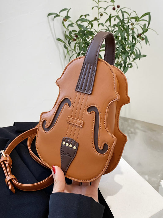 This Chic Violin-Inspired Versatile Shoulder Bag is perfect for stylish women who appreciate unique and elegant accessories. Made with high-quality materials, this bag features a violin-shaped design that is both functional and fashionable. With multiple compartments and a versatile shoulder strap, it offers convenience and style in one.