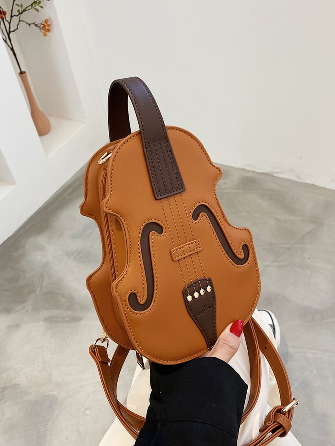 This Chic Violin-Inspired Versatile Shoulder Bag is perfect for stylish women who appreciate unique and elegant accessories. Made with high-quality materials, this bag features a violin-shaped design that is both functional and fashionable. With multiple compartments and a versatile shoulder strap, it offers convenience and style in one.
