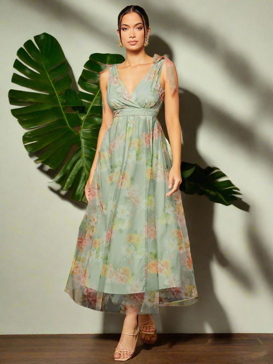Add a touch of elegance to your next garden party with our Garden Party Perfection Dress. The beautiful floral print and delicate tie shoulder detail make this mesh dress a must-have. Perfect for any occasion, bring out your inner fashionista with this stunning piece.