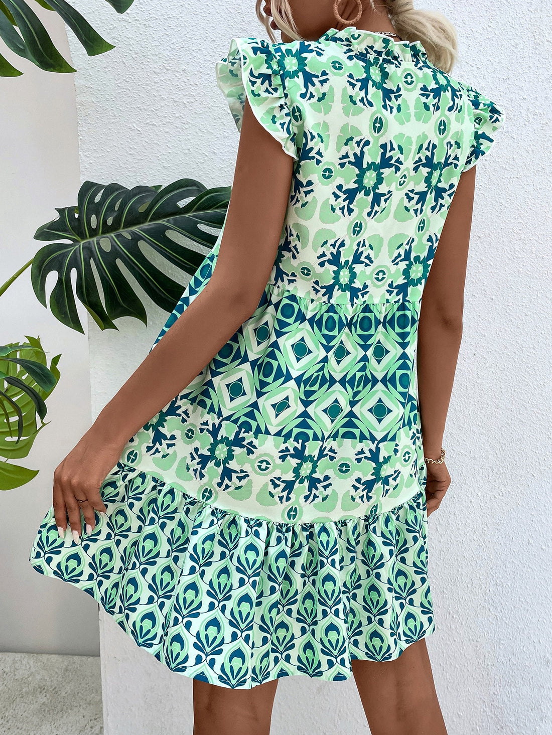 Unleash your bold and carefree style with our Chic Geo Print Dress! Designed with a playful ruffle hem and adorable butterfly sleeves, this dress is perfect for your next vacation or a day at the beach. It's the ultimate combination of fashion and functionality!