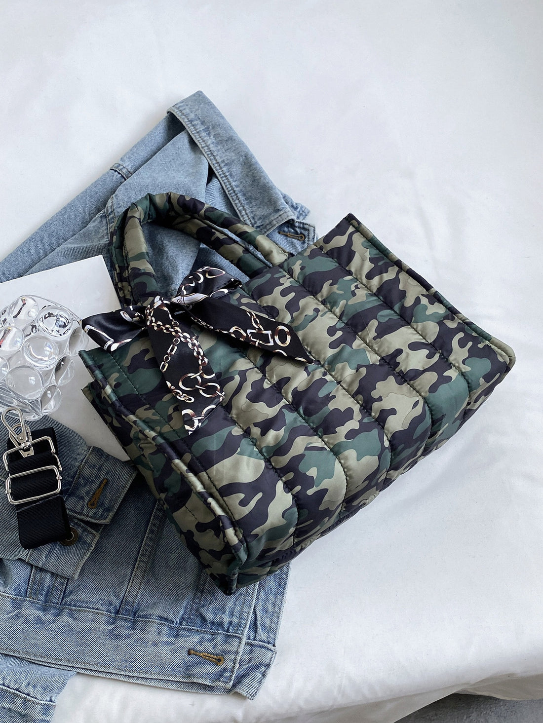 Elevate your style with Camouflage Chic: Bow-Detail Skinny Scarf & Quilted Top Handle Bag. The versatile scarf adds a touch of femininity while the spacious, quilted bag keeps your essentials organized. Perfect for any occasion, this set adds a trendy twist to any outfit.