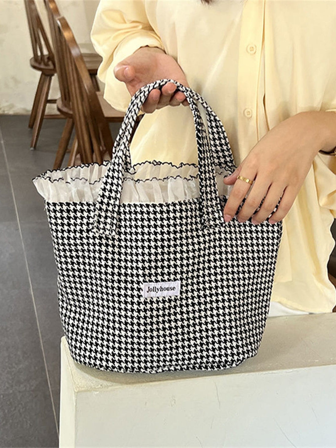 Stay stylish and organized for the school year with our Ruffle Trim Square Bag. The perfect essential for any student, it features a trendy ruffle trim design and spacious square shape, providing both fashion and functionality. Keep all your essentials in one stylish place.