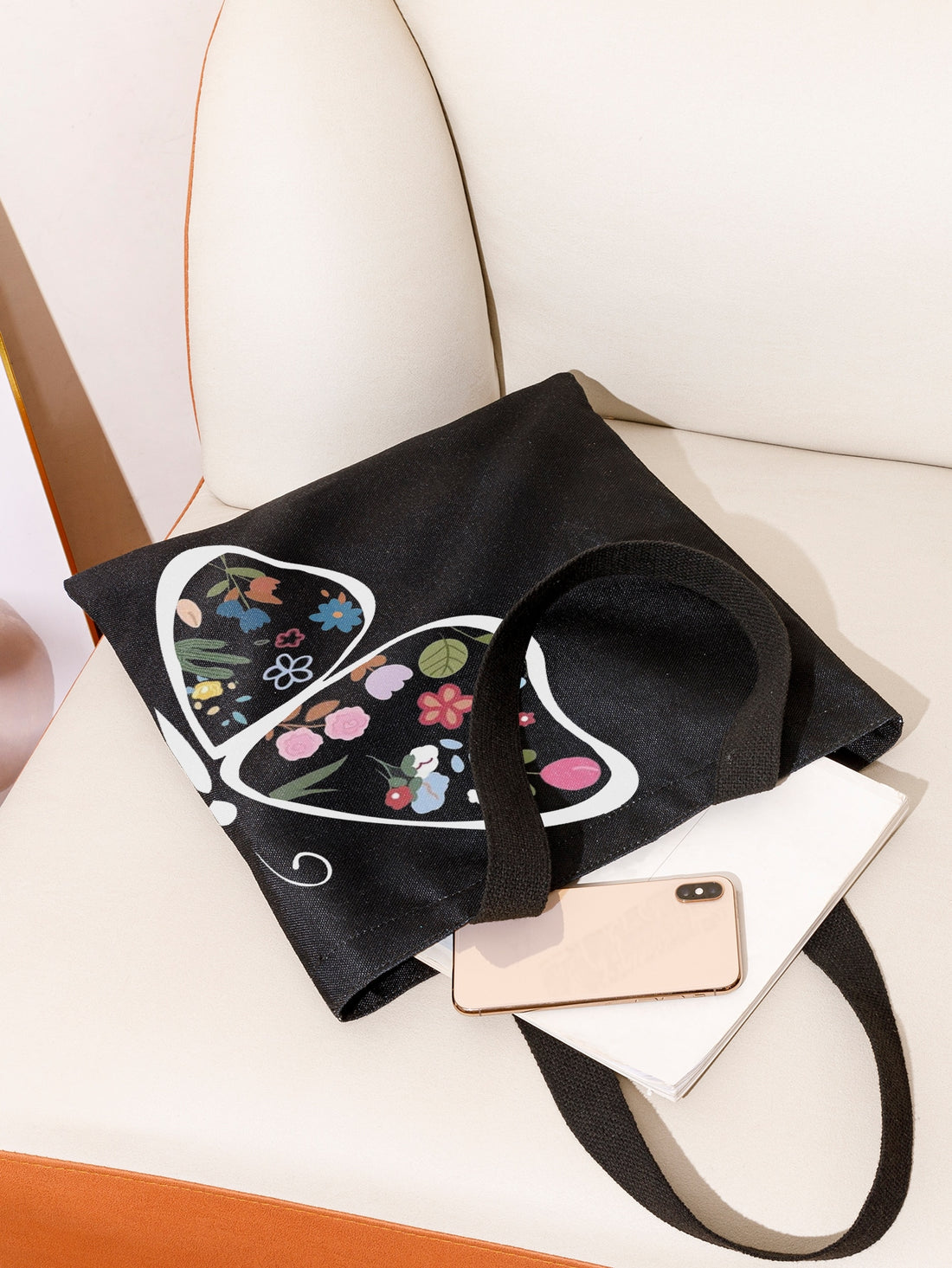 Introducing the Fluttering Blooms Shopper Tote! This essential bag features a stunning butterfly and floral print, sure to make a statement. Made with durable materials and comfortable straps, it's perfect for everyday use. Add a touch of nature and style to your wardrobe with this must-have tote.