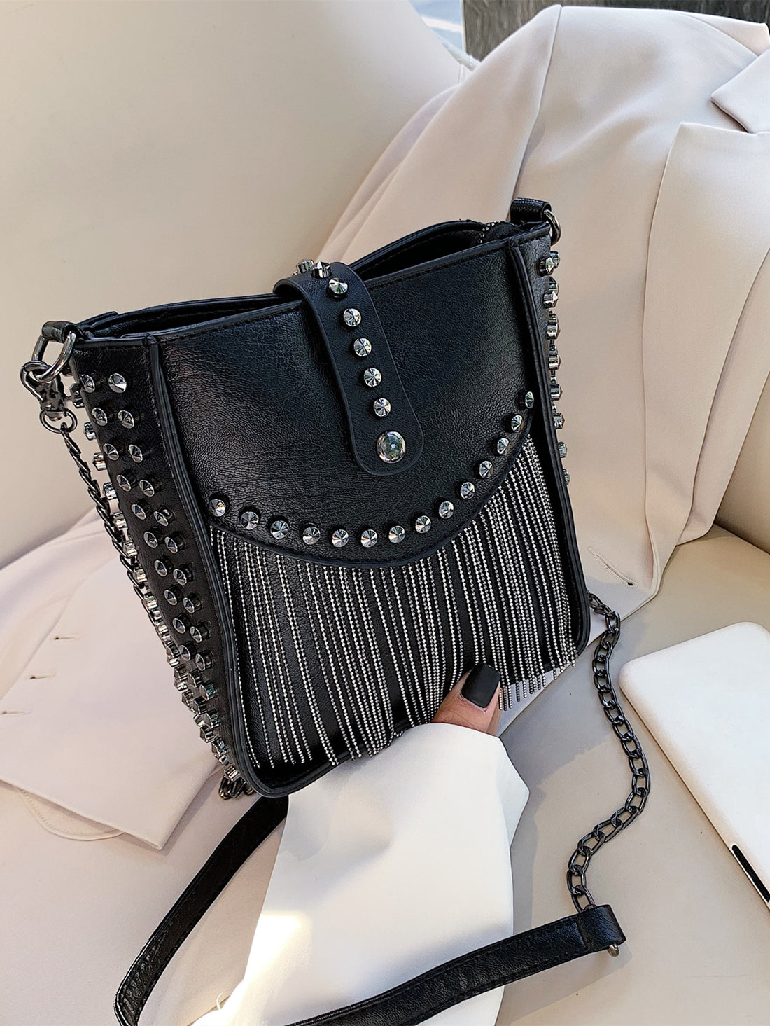Elevate your style with our Chic Mini Fringe Studded Bucket Bag. Effortlessly add a touch of glamour with its unique studded design and trendy fringe detailing. This bag is perfect for any occasion, providing both style and convenience in a compact size. Complete your look with this must-have accessory.