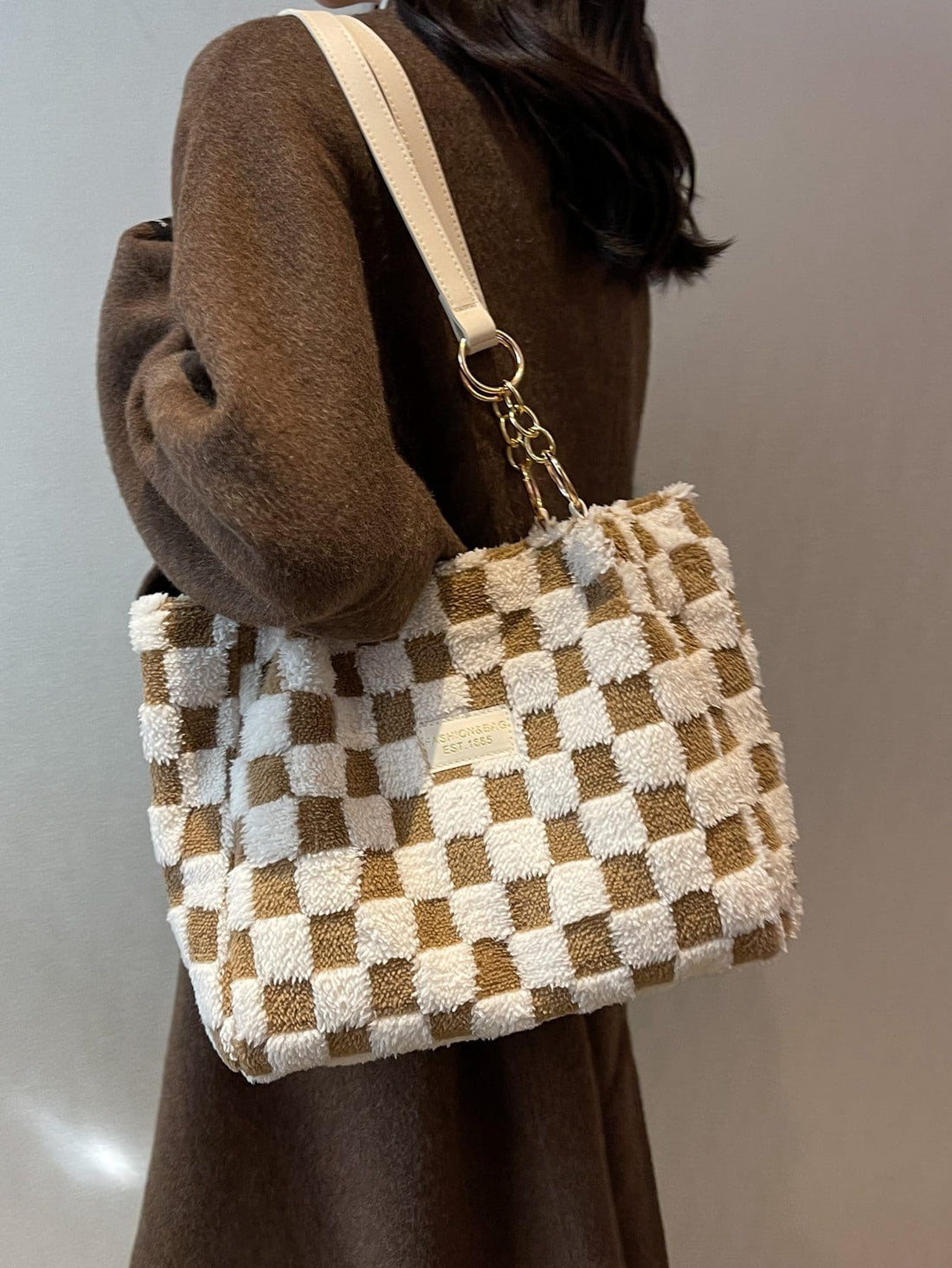 Elevate your professional and student style with our Chic Checkered Fuzzy Shoulder Tote Bag. The perfect accessory for any outfit, this bag combines fashion and functionality with its soft, touchable texture and spacious interior. Stay organized and stylish on-the-go with this must-have tote.