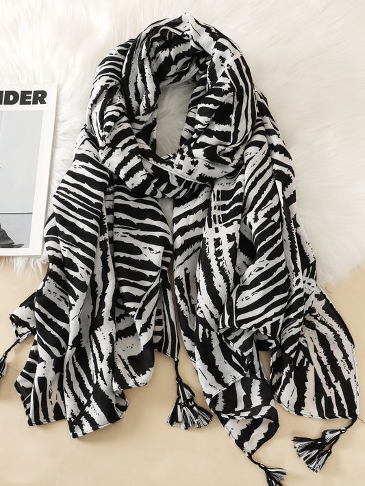 Add a touch of wild and stylish flair to your wardrobe with our Zebra Striped Print Tassel Decor Scarf. The unique print and tassel accents make this scarf a bold and fashionable statement piece. Made with high-quality materials, it's perfect for any occasion.