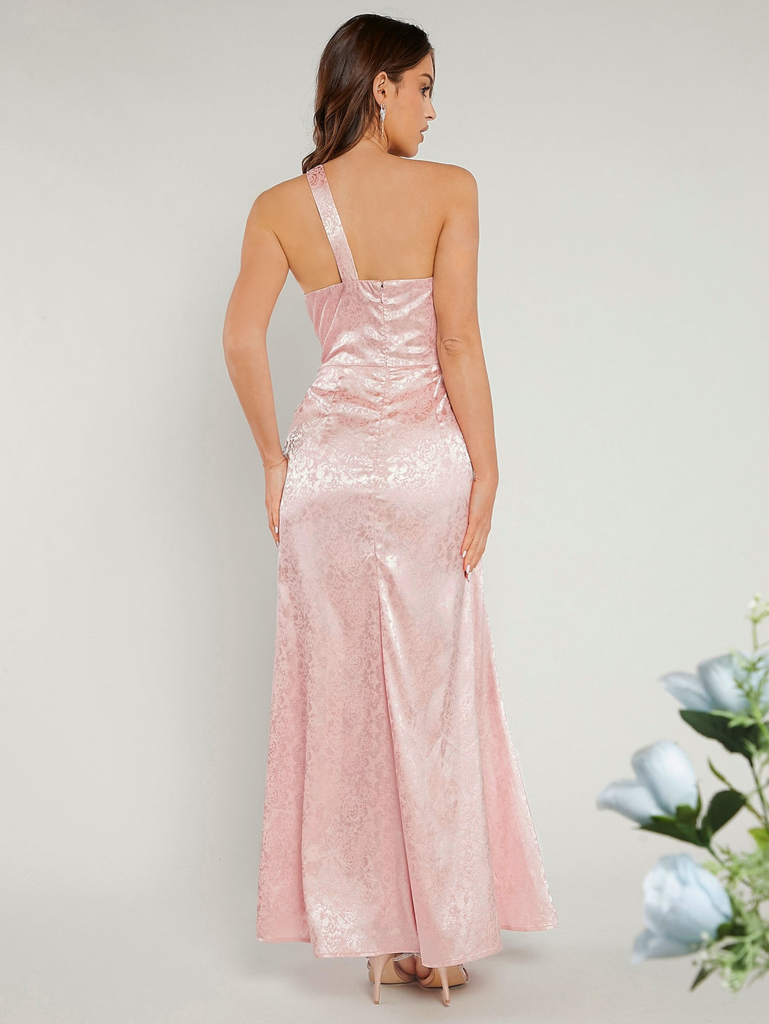 Steal the spotlight in this stunning one-shoulder bridesmaid dress that's anything but ordinary! Featuring an eye-catching jacquard fabric with delicate ruffles, this gown brings just the right amount of drama and elegance to any celebration. The asymmetrical neckline creates a chic, modern silhouette that flatters every figure, while the luxurious texture adds depth and dimension. Whether you're walking down the aisle or dancing the night away, this dress promises to turn heads and make you feel absolutely