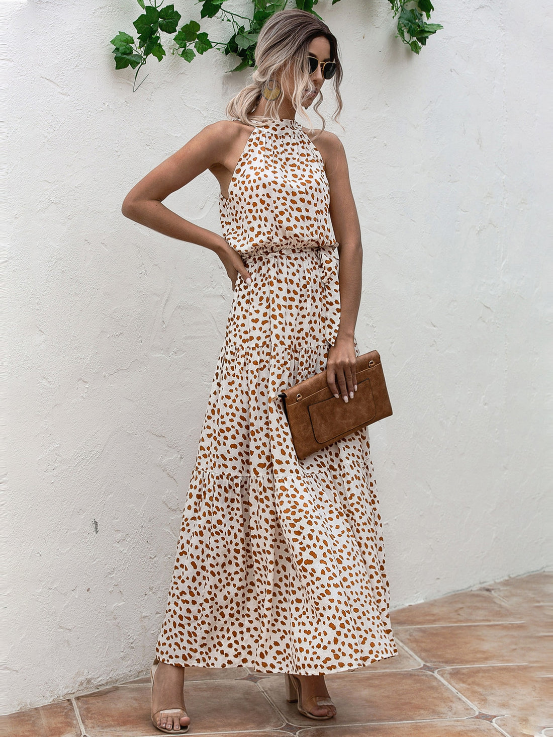 This Tropical Escape dress features a vibrant allover print, layered hem, and belted halter design. Perfect for any tropical escape, this dress is both fashionable and functional. The unique layered hem and belted halter provide a flattering silhouette, making it a must-have addition to your wardrobe.