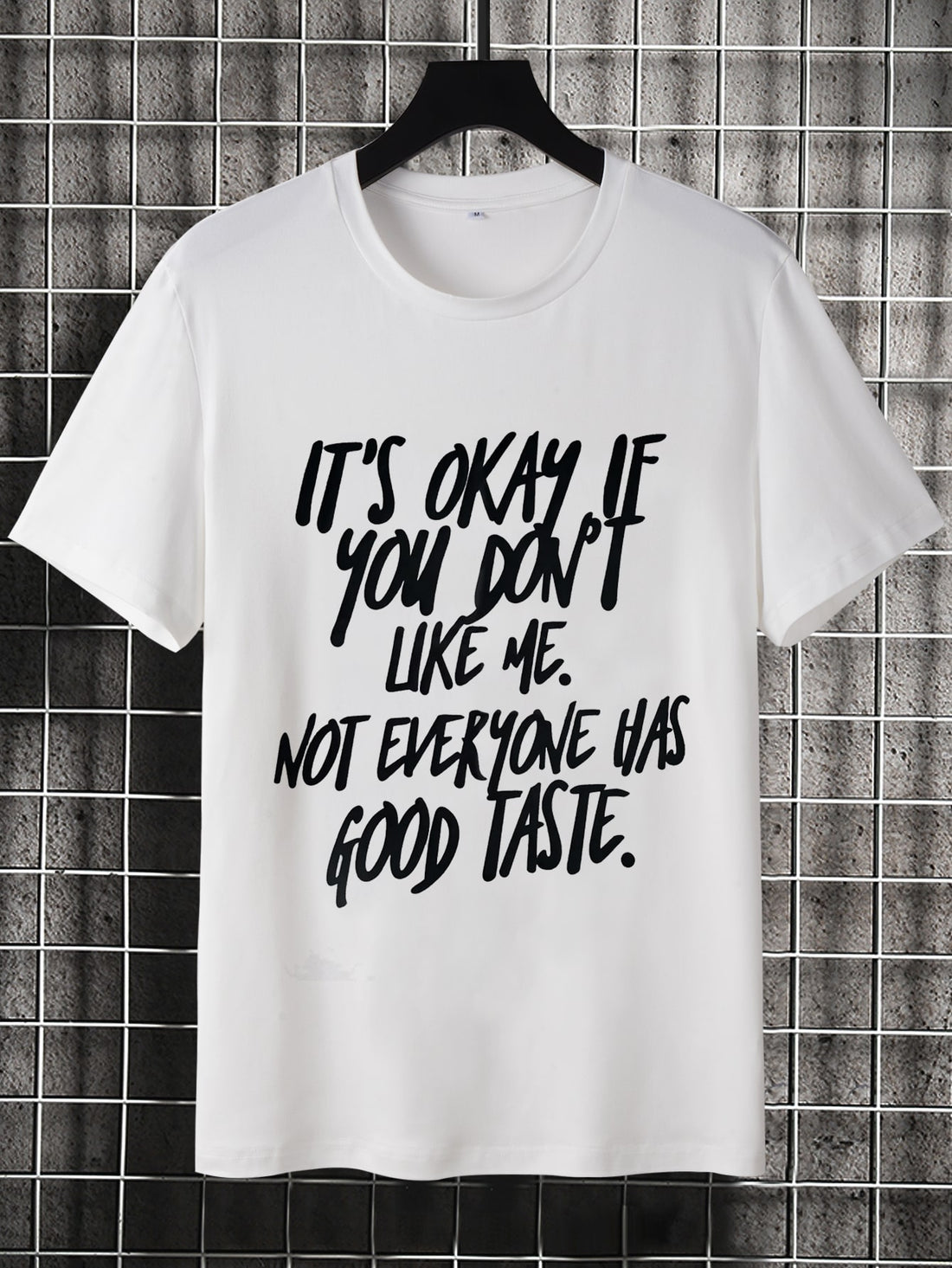 Make a statement in this stylish Men's Slogan Graphic Tee. With a bold slogan design, this shirt is sure to turn heads. Stand out from the crowd and show off your unique sense of style. Comfortable and fashionable, this tee is a must-have for any fashion-forward man.