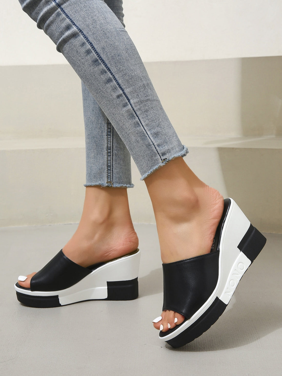 Indulge in ultimate summer style with Vacation Vibes: Black and White Sexy Peep Toe Slippers. The perfect addition to any beach or pool day, these peep toe slippers offer a comfortable and stylish way to show off your pedicure. With a sleek black and white design, these slippers are sure to elevate your summer look.