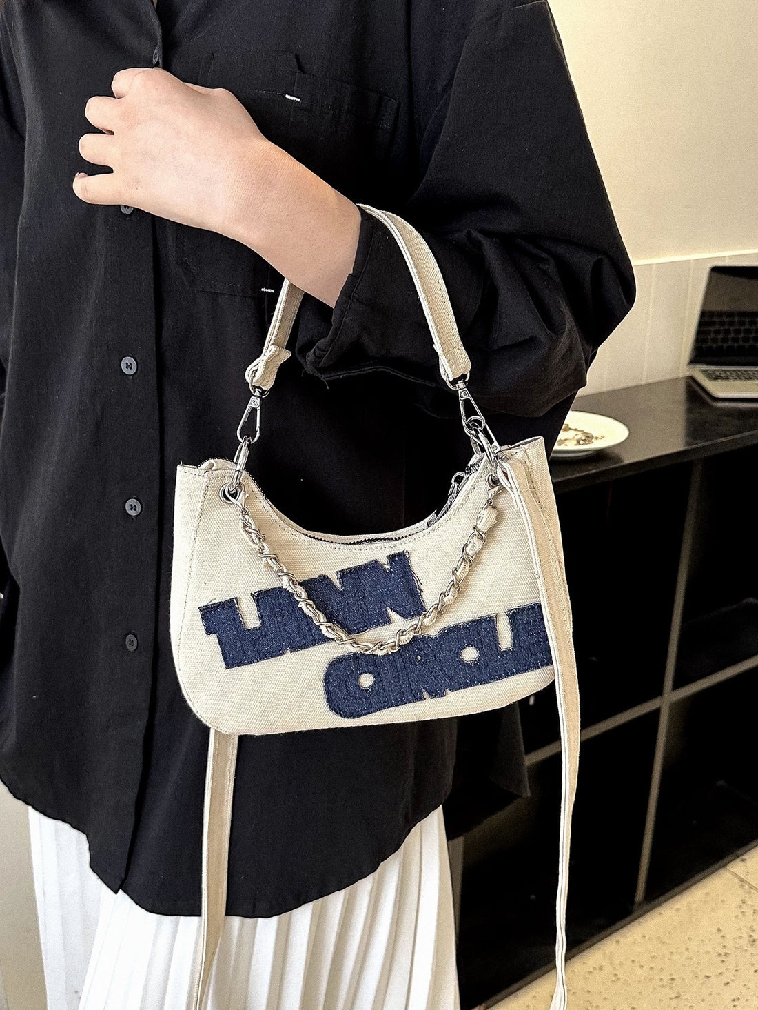 Introducing our Chic and Practical Chain Hobo Bag, perfect for the modern woman on the go. With its lightweight design and stylish chain embellishment, it's the perfect blend of fashion and function. Ideal for business casual settings, this bag is as versatile as it is chic. Expertly crafted for convenience, it's the perfect accessory for busy professionals.