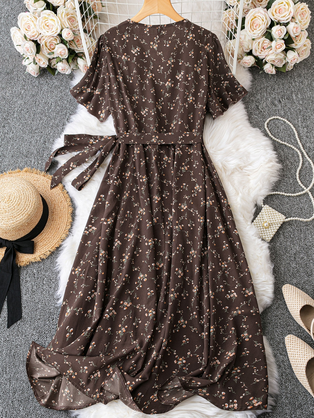 Introducing our Ditsy Floral Print Butterfly Sleeve Maxi Dress! With a playful print and fluttery butterfly sleeves, this dress is perfect for any occasion. The ruffle trim and knot detail add a touch of whimsy to this already charming piece. Get ready to turn heads and make a statement in this dress!