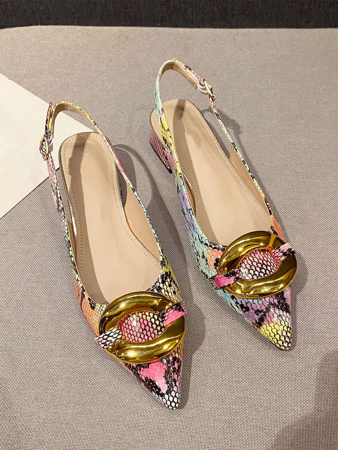 Elevate your style with these Chic Snakeskin Embossed Pointed Toe Slingback Flats. Made with intricate metal accents, these flats are perfect for any occasion. The pointed toe design adds a touch of sophistication, while the slingback straps provide a secure fit. Stand out from the crowd with these stylish and comfortable flats.