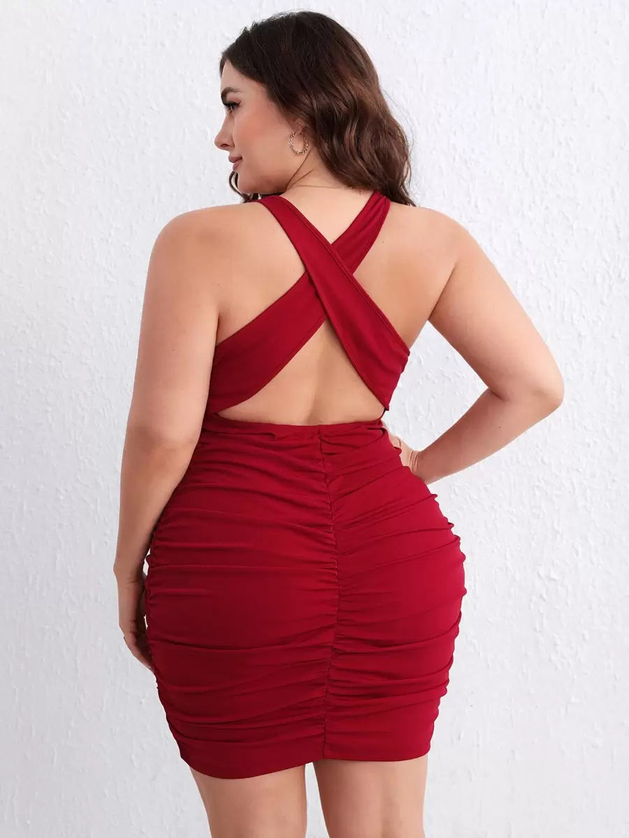 Turn heads in this stunning plus-size bodycon dress that celebrates your curves with style! The crisscross backless design creates an alluring silhouette, while strategic ruching flatters your figure beautifully. Perfect for date nights, parties, or whenever you want to feel confident and fabulous, this dress combines bold fashion with comfort. The sleek bodycon fit hugs you in all the right places, making it a versatile go-to for any occasion where you want to make a statement. Dress it up with heels or ke